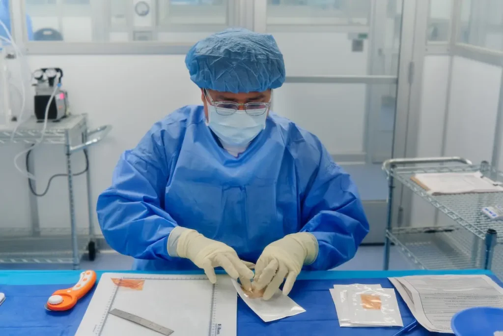 A lab technician packages a placental graft used for advanced chronic wound care.