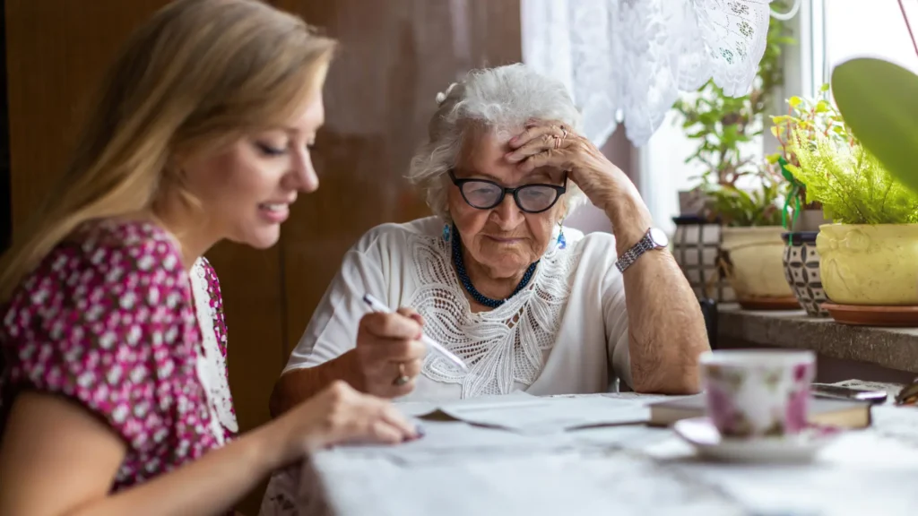 An elderly woman and her daughter review Star Rating information for home health agencies.