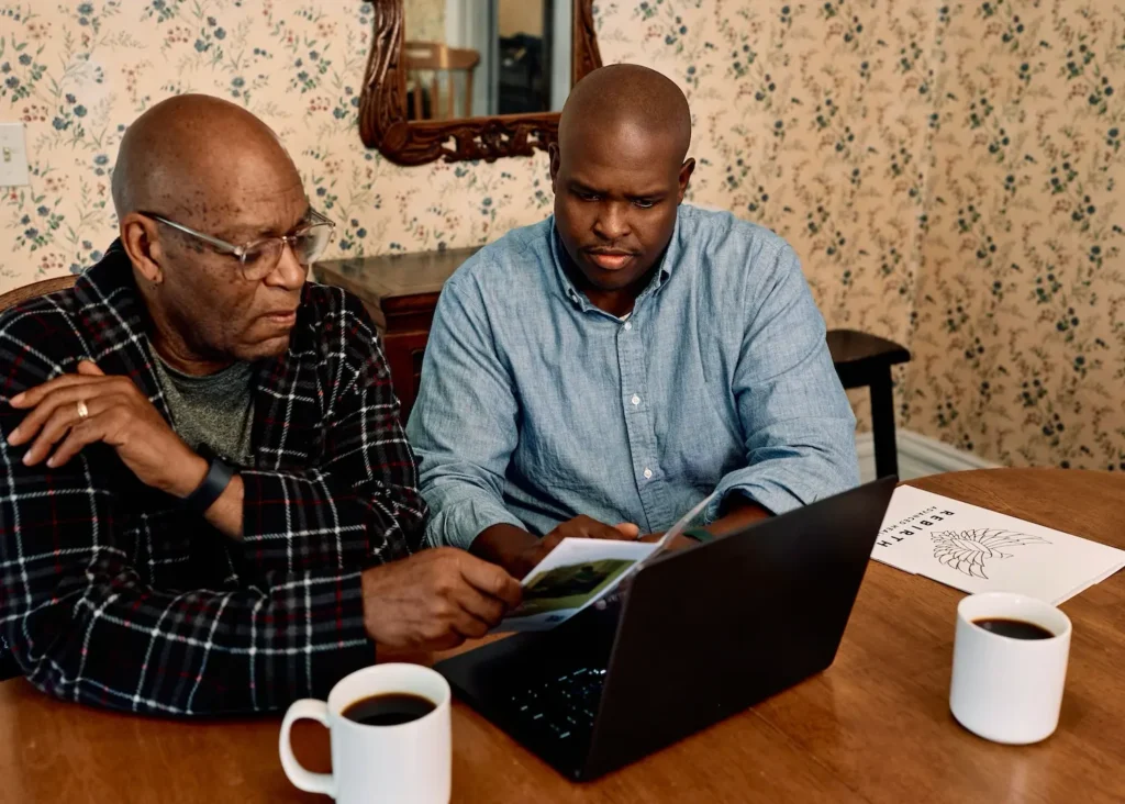 A son goes through wound care insurance coverage with his father, who has a chronic wound.